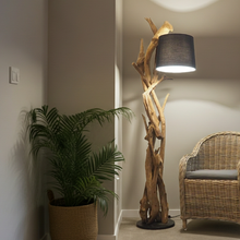 Load image into Gallery viewer, Room interior with a wooden floor lamp, potted plant, and wicker chair.