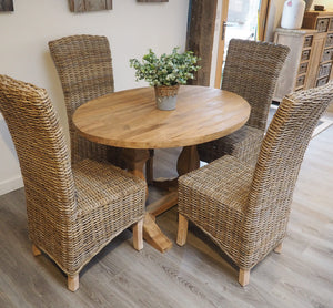 120cm oval reclaimed teak dining table with refectory-style base pictured in a dining set with 4 natural Kubu rattan chairs