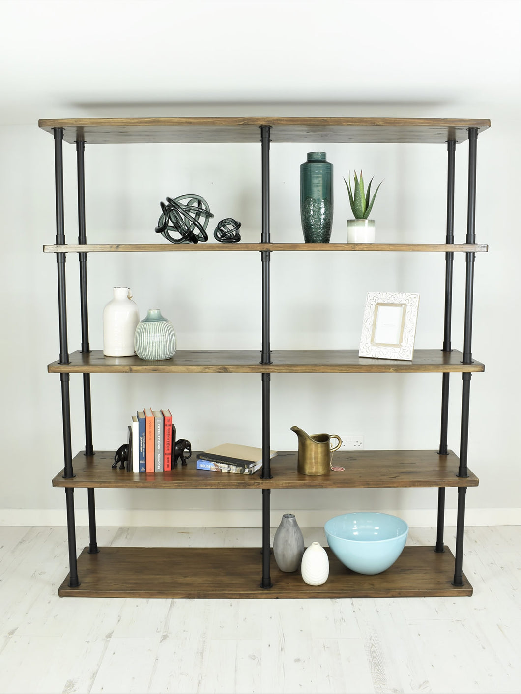 Vintage industrial style shelving unit. Items displayed on shelves.
