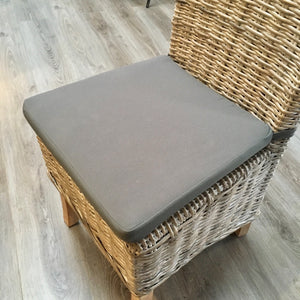 Kabu whitewashed chair with grey cushion.
