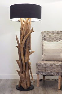 Unique driftwood style teak root floor lamp illuminating space