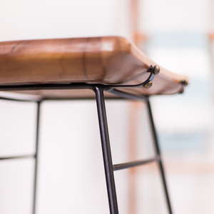 Close-up of solid teak wood seat on metal kitchen stool