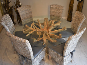 Reclaimed teak root dining table paired with wicker dining chairs