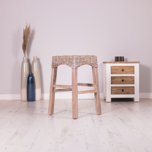 Chic backless whitewash wicker kitchen counter stool with a classic country or coastal look